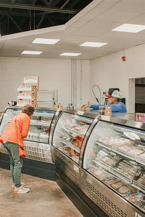 Customer Interacts at Local Butcher Shop Counter · Free Stock Photo