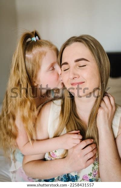 Daughter Kisses Mom Smiling Hugging Little Stock Photo 2258431557