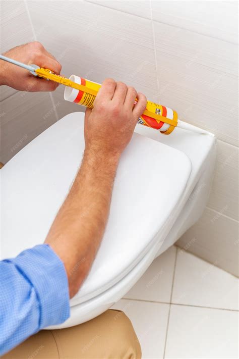 Premium Photo | Close up of a plumber fixing toilet bathroom cartridge