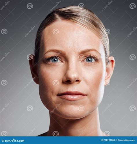 Beautiful Mature Woman Posing in Studio Against a Grey Background Stock