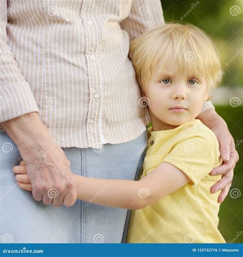 Beautiful Granny and Her Little Grandson Walking Together in Park Stock