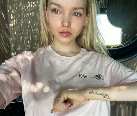 Dove Cameron's healed gun and rose tattoo.