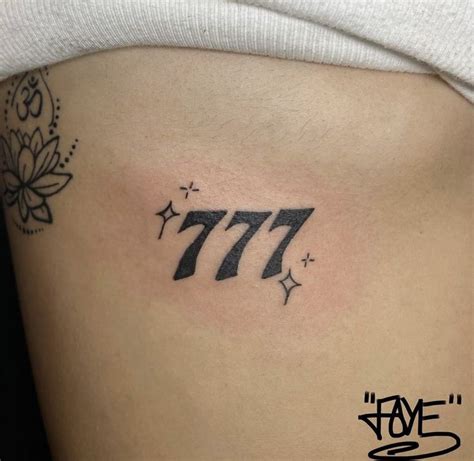 a woman's stomach with the number 777 tattoo on her left side ribcage