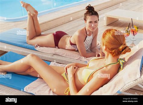 Friends relaxing in pool copy space hi-res stock photography and images
