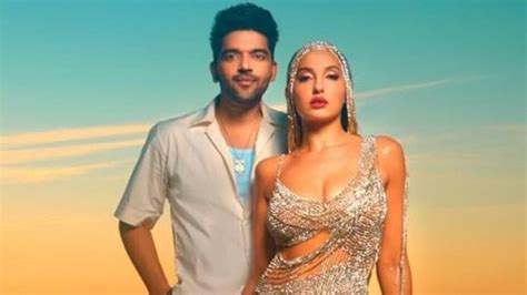 Nora Fatehi is a vision in silver cut-out dress with Guru Randhawa for ...