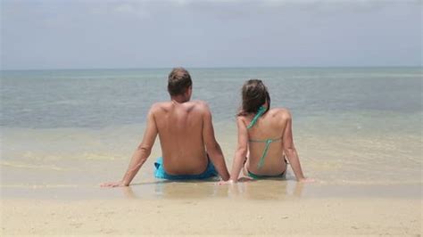 stokovaya fotografiya  couple nudist sitting  beach