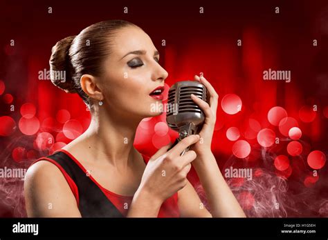 attractive female singer with microphone Stock Photo - Alamy