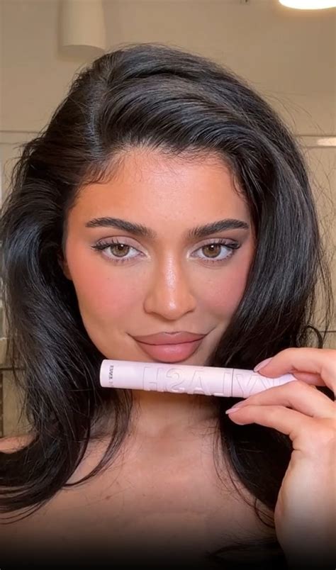 Kylie Jenner goes nearly naked in just a towel as she applies her
