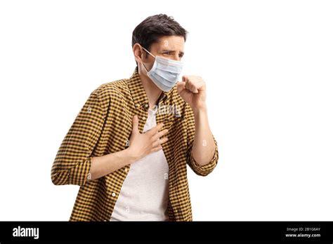 Young man coughing and wearing a face mask isolated on white background ...