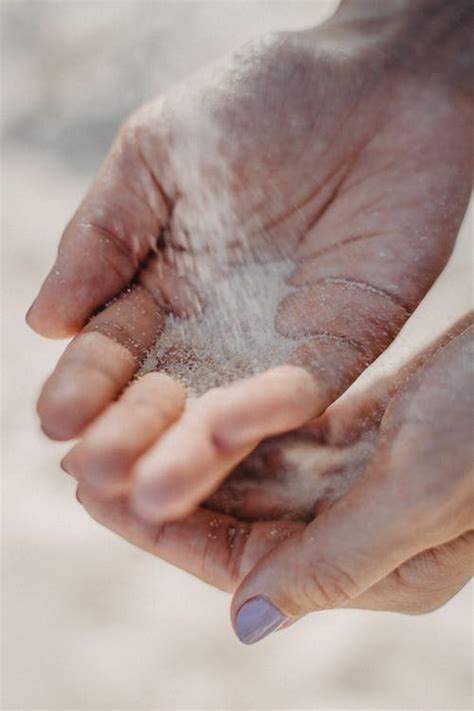 woman spilling sand  hands  stock photo