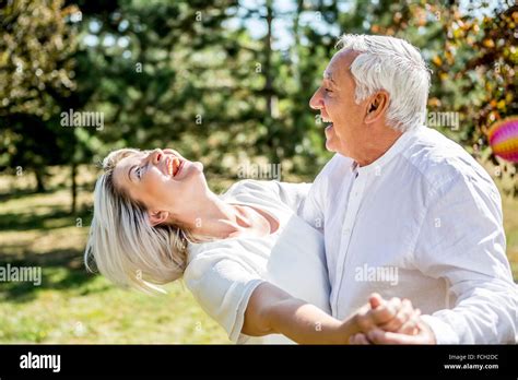 Happy elderly couple dancing outdoors Stock Photo - Alamy
