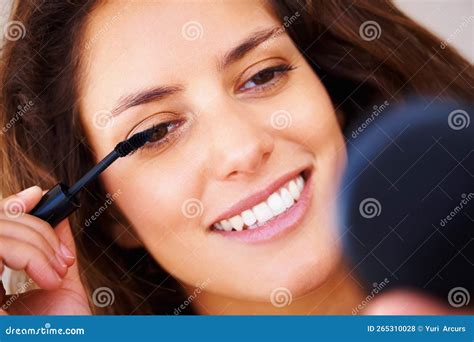 beautiful woman applying mascara closeup  beautiful woman applying
