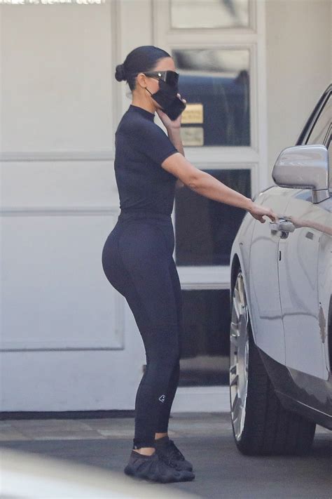 Kim Kardashian shows off her famous curves in skintight leggings as she