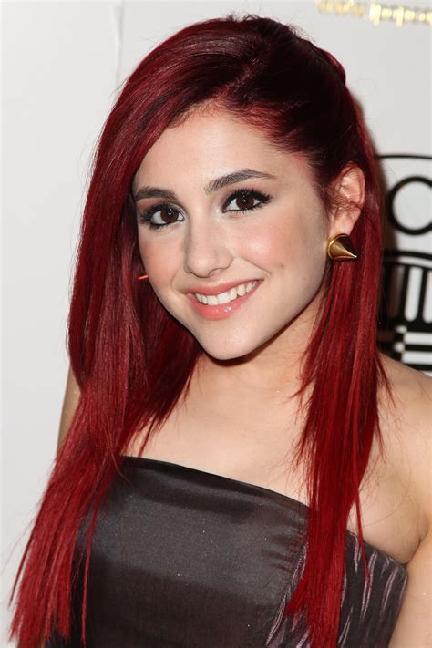 Her scarlet coif is decidedly longer, with rosy cheeks and fanned-out