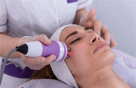 premium photo  young woman undergoing  facial radiofrequency face