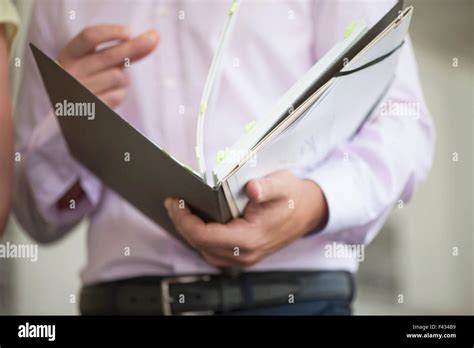 office worker flipping  binder stock photo alamy