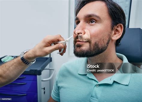 adult man  rhinoscopy  ent office doctor  nasal speculum