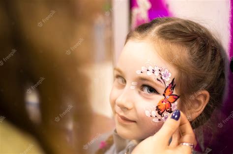 Premium Photo | Childrens makeup face paint drawings girls face ...