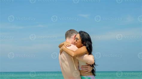 couple hugs  kisses   beach   summer vacation