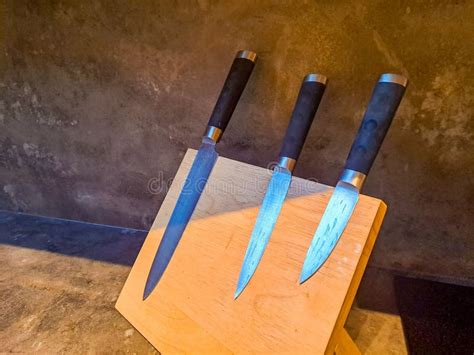 A Set of Kitchen Knives Lies on a Wooden Board, Side View, Space for ...