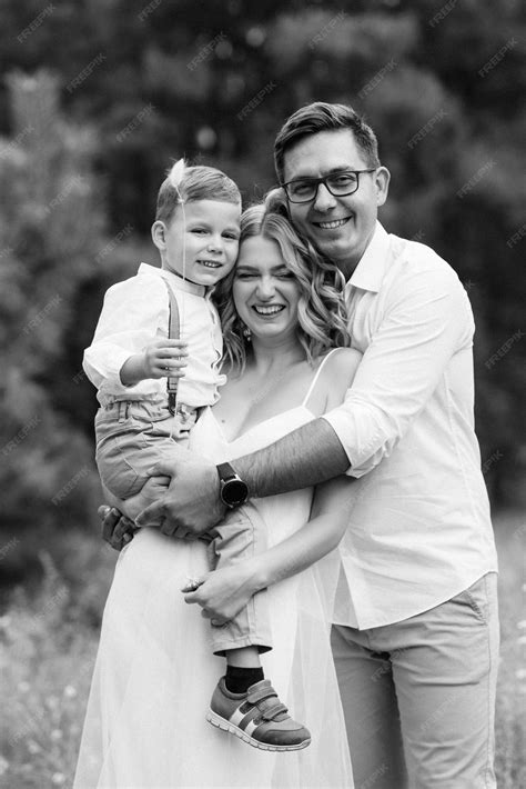 Premium Photo | Happy family three dad mom and son on a walk