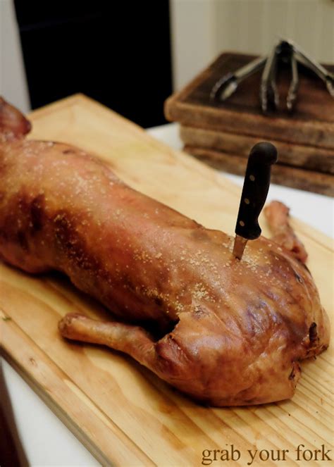 suckling pig     hand paddington grab  fork