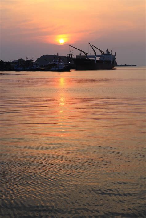 Cargo ship in the harbor at sunset 10448452 Stock Photo at Vecteezy