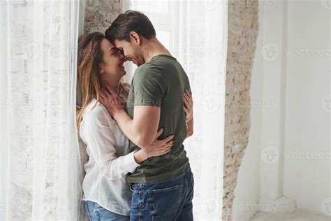 Joking around. Lovely couple kissing and enjoying each other near the