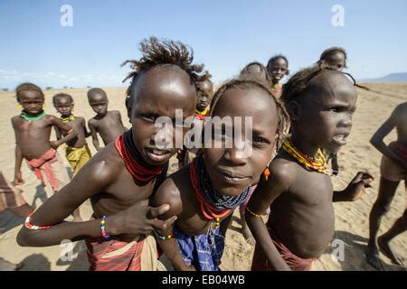 Daasanach people, kids, children, boys playing with dugout canoe Stock ...