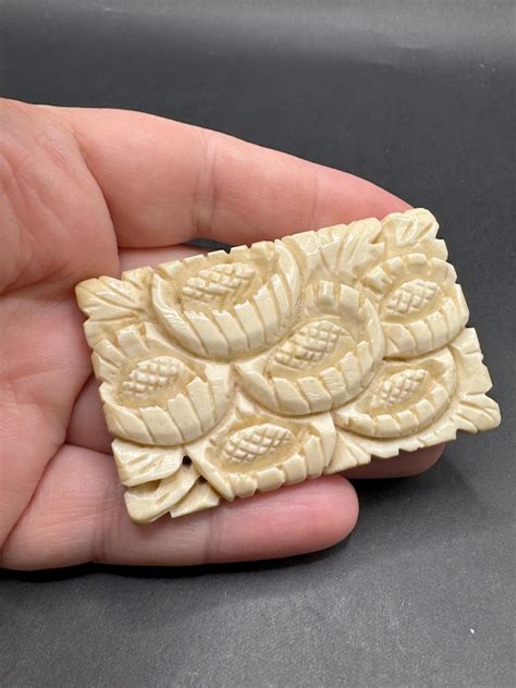 carved bone brooch gem