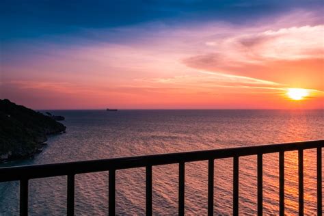 View of Sunset the balcony in the sea,with clouds and water reflection