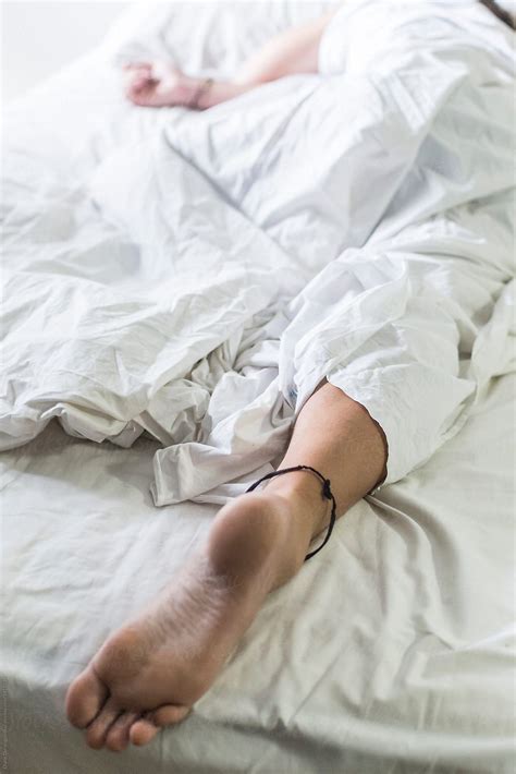 "Foot Of Sleeping Man" by Stocksy Contributor "Diane Durongpisitkul
