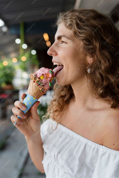 Free Photo | Side view woman licking ice cream cone