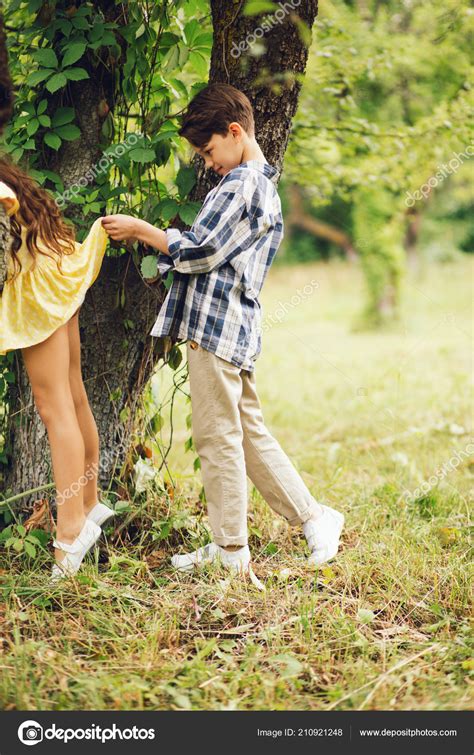 Little boy looking under girls skirt. Stock Photo by ©svyatoslavlipik