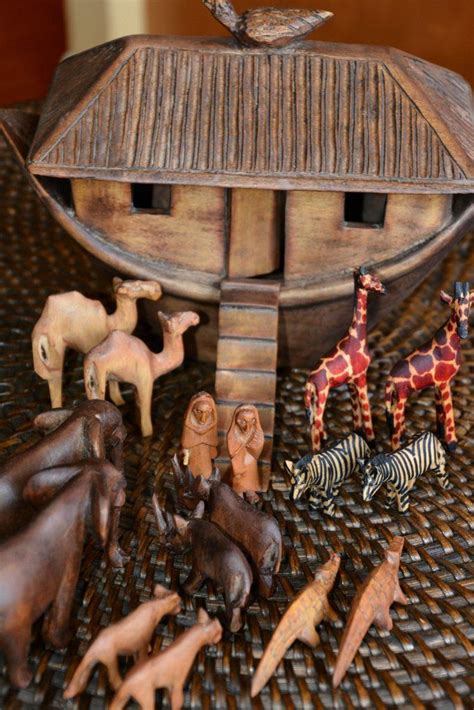 wooden toy animals sitting on top of a woven tablecloth covered floor ...