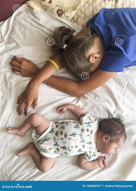 Two Sisters a Infant Baby and Teen Age Girl Sleeping on Bed Together
