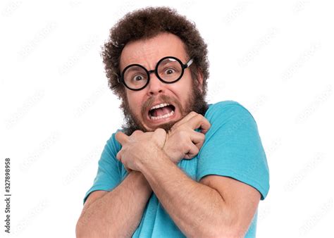 Crazy Scared Man with funny Curly Hair in Eyeglasses looks worried ...