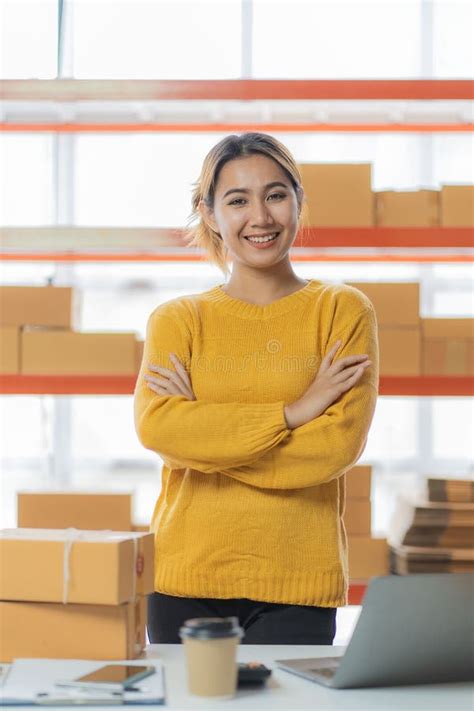 beautiful asian startup owner stays happily  home  packages