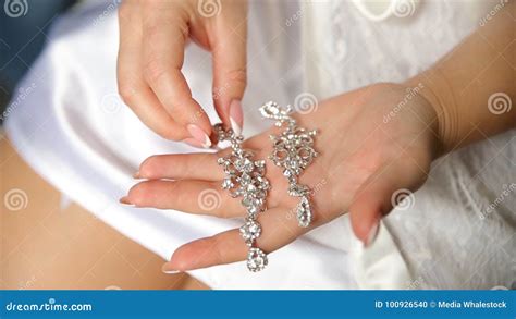 Wedding Earrings on a Bridal Hand, Bride`s Morning and Jewelry ...