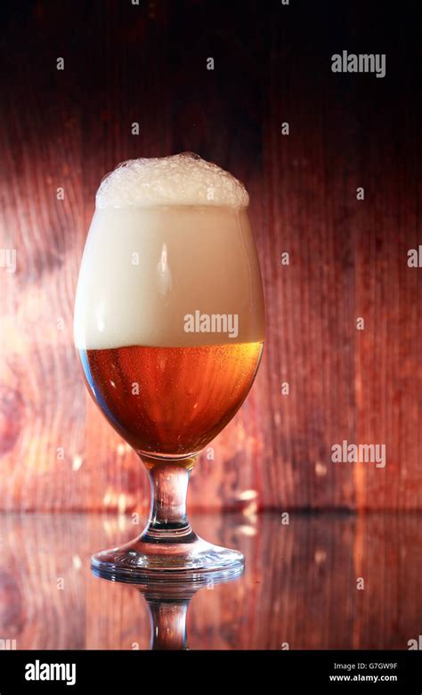 glass full  beer  foam  wooden background stock photo alamy