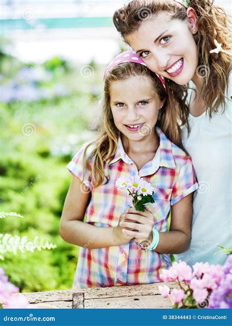 Mom and Daughter Have Fun in the Work of Gardening Stock Image - Image