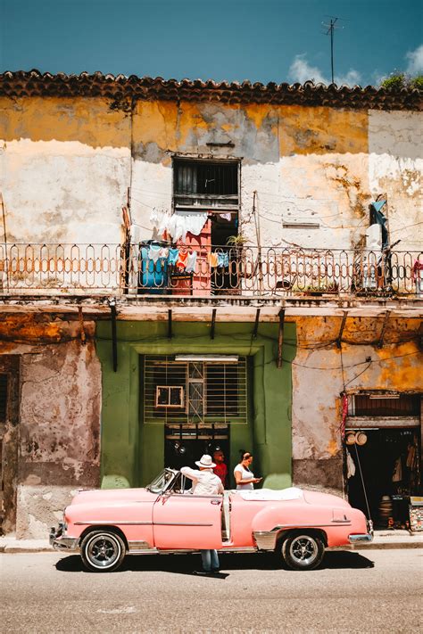 Download Pink Car Parked On Cuban Street Wallpaper | Wallpapers.com