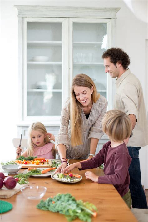 "Family Preparing A Healthy Meal In The Kitchen At Mediterranean Home