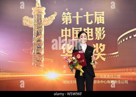 Chinese actress Chen Jin poses with her trophy after winning the ...