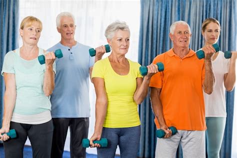 Premium Photo | Seniors exercising with weights