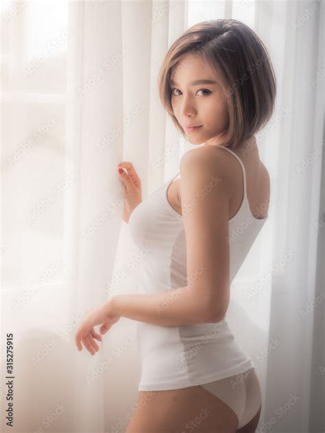 Sexy asian woman lying on the bed in the bedroom Stock Photo | Adobe Stock