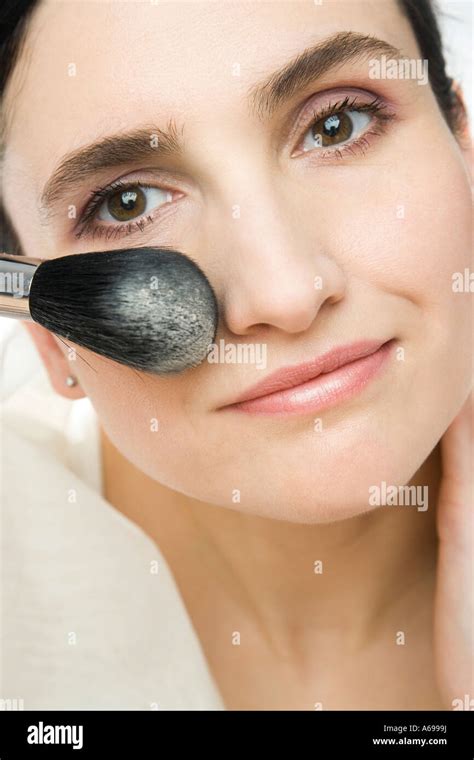 woman applying powder stock photo alamy