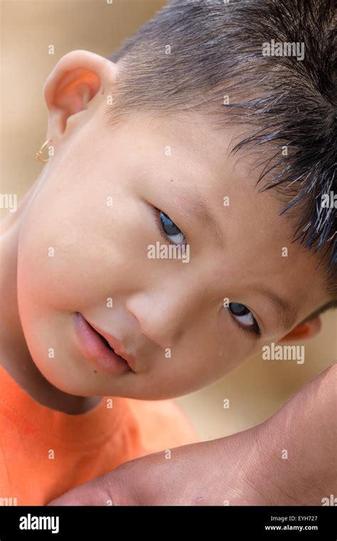 Portrait of a little mongoloid boy happy and innocent with copy space ...