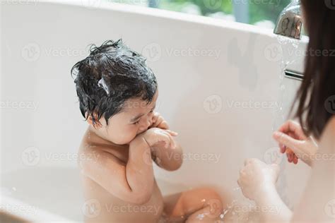 Asian cute kid girl toddler having a bath wash hair cleaning bathing