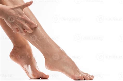 Female legs with dry itchy skin against white background 16253316 Stock